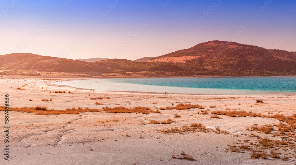 Panoramic view of the white sandy beach with grass bushes on the famous lake Salda in Turkey. Wonders of nature and turkish maldives concept