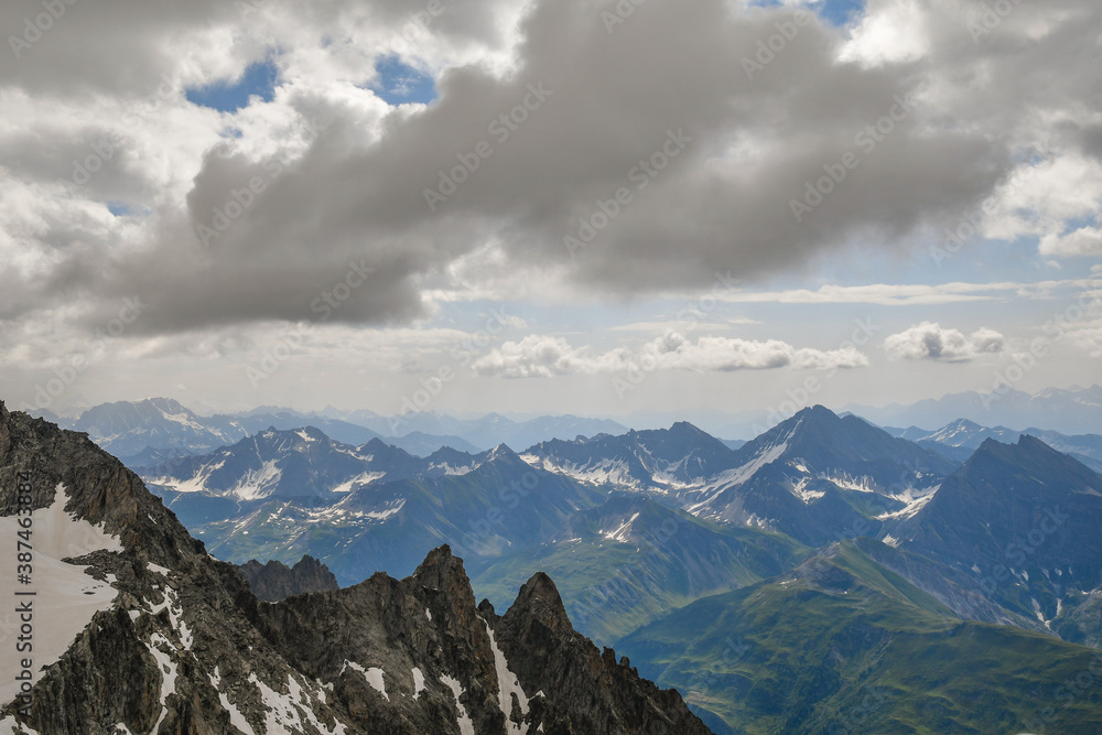 Scenic view from the Mont Blanc massif of the Alps range on the border between Italy, France and Switzerland in a cloudy summer day, Courmayeur, Aosta Valley, Italy