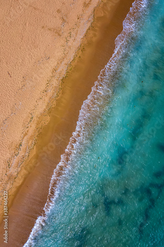 Top view aerial photo from drone to the beautiful sea and yellow sand.