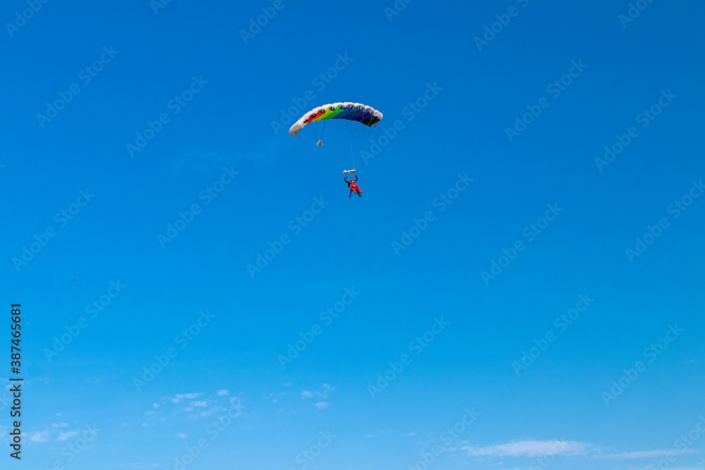 Parachutist is flying in the sky, sunny contrast image. Parachutist is flying in the sky, sunny contrast image.