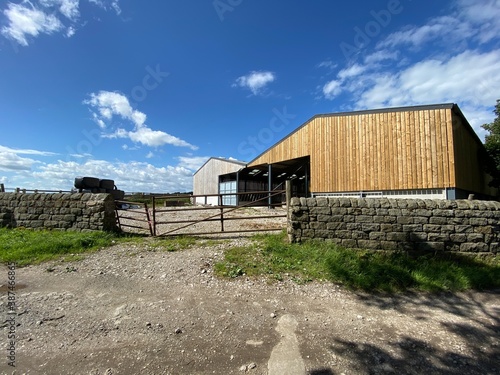 Farm outbuildings, set against a vivid blue sky in, Newall with Timble, Harrogate, UK