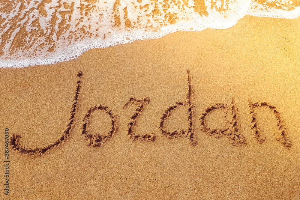 Fototapeta premium Jordan title on the sand beach of the coast Red sea. Wave.