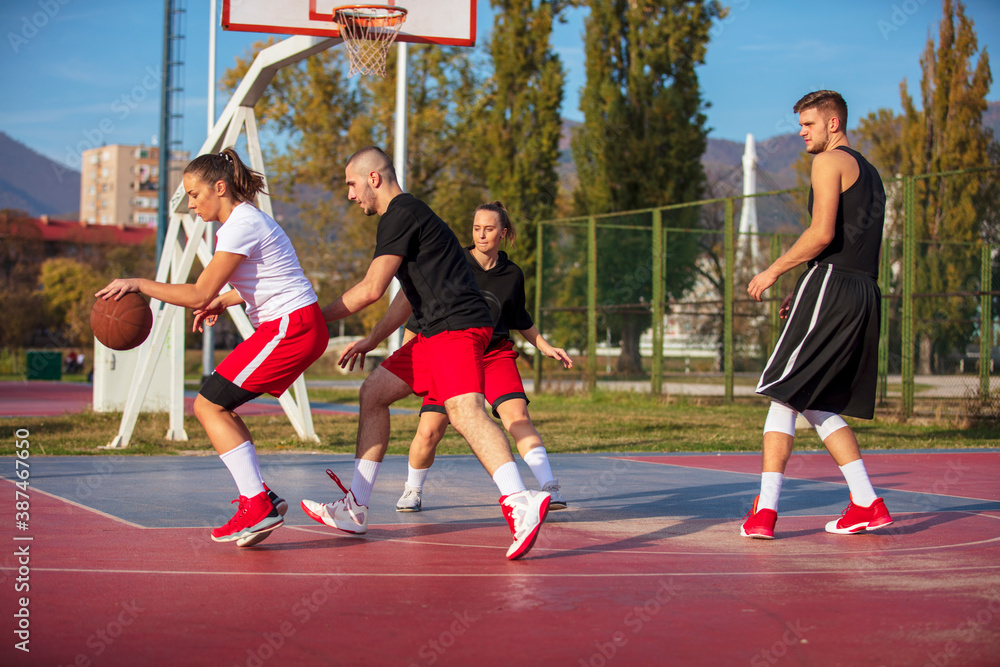 Group Of Young Friends Playing Basketball Match