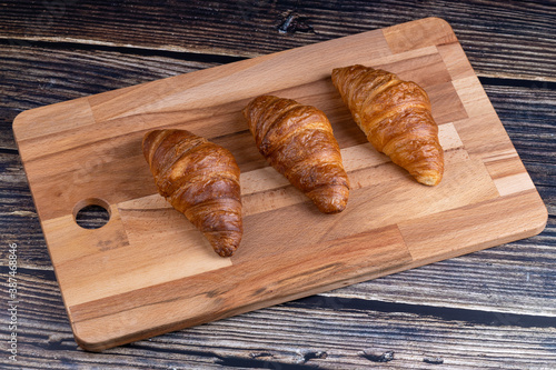 Croissants on a wooden board.