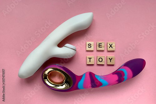 Sex toys. Two intime vibrator on a pink background. Inscription SEX TOY. Useful for adult, sex shop photo