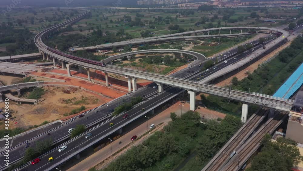 An aerial shot of the Two Delhi Metro Trains crossing each other at Mayur Vihar, New Delhi, India An aerial shot of the Two Delhi Metro Trains crossing each other at Mayur Vihar, New Delhi, India
