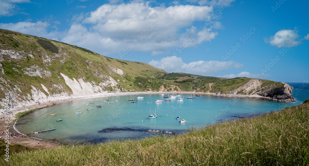 Panoramic view of Lulworth Cove on a summers day in Lulworth, Dorset, UK