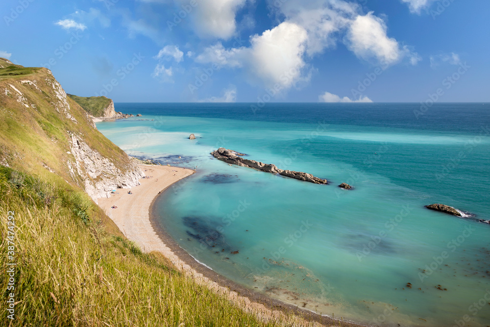 View of the Lulworth coastline  with milky coloured sea on a warm summers day.