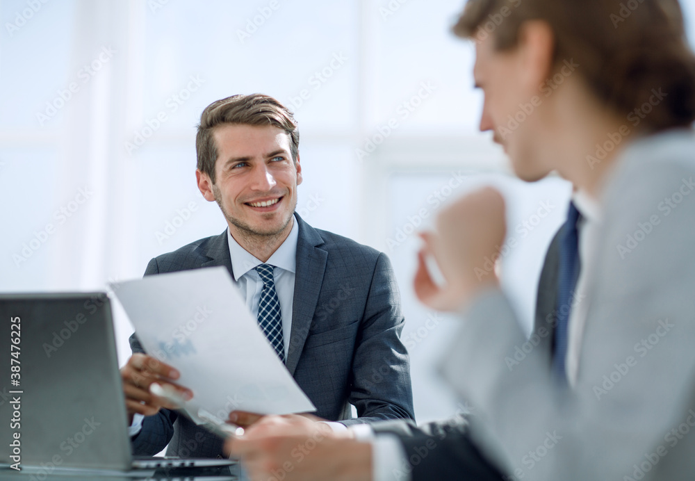 boss discusses with employees business documents. boss discusses with employees business documents.
