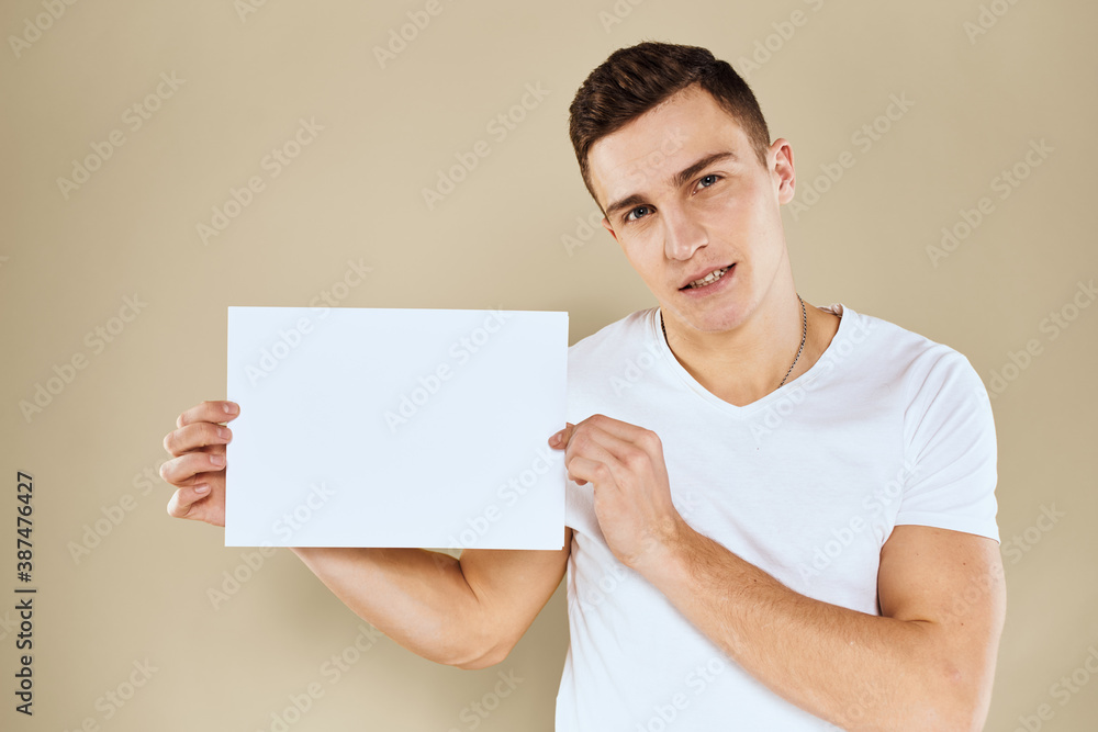 man in white t-shirt sheet of paper in hands Copy Space cropped view beige background man in white t-shirt sheet of paper in hands Copy Space cropped view beige background
