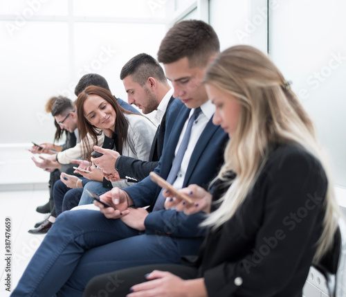 young employees looking at their smartphone screens