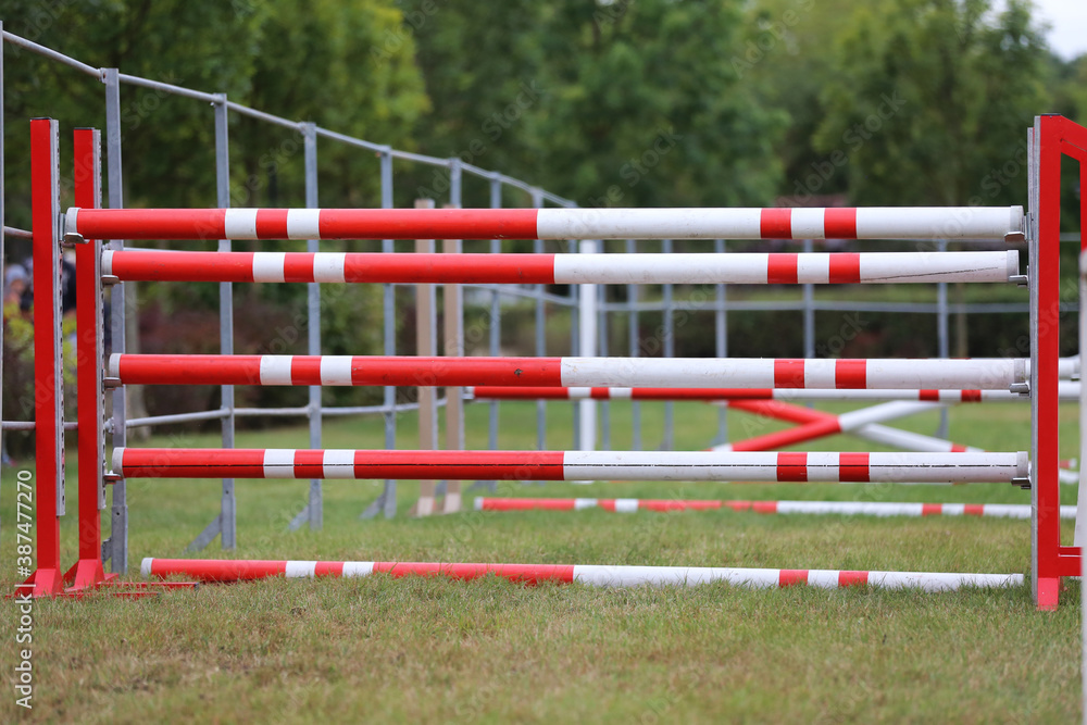 Obstacles poles barriers for jumping horses as a background Obstacles poles barriers for jumping horses as a background
