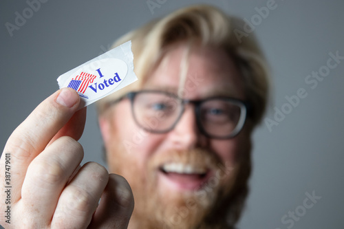 Man Holding I Voted Sticker