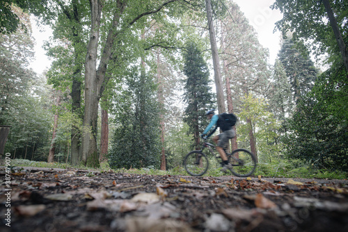 unknown person riding a bike in the forest
