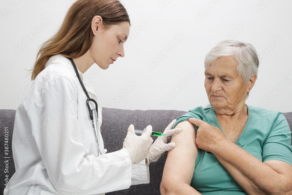 Senior woman receiving vaccine. Medical worker vaccinating an elderly patient against flu, influenza, pneumonia or coronavirus. Senior woman receiving vaccine. Medical worker vaccinating an elderly patient against flu, influenza, pneumonia or coronavirus.
