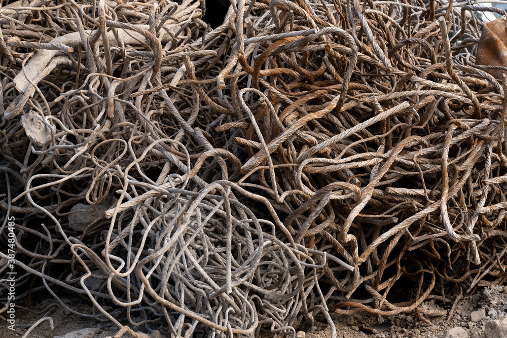 A Heap of construction scrap debris Armature iron round rods pieces of broken concrete curved metal rods A Heap of construction scrap debris Armature iron round rods pieces of broken concrete curved metal rods