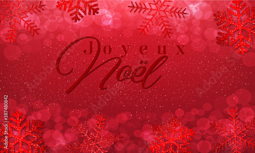 carte ou bandeau sur "joyeux Noël" en rouge foncé sur un fond rouge avec des flocons et des ronds en effet bokeh rouge 
