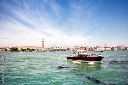A hotel river shuttle cruises along Venice's Grand Canal on a summers day