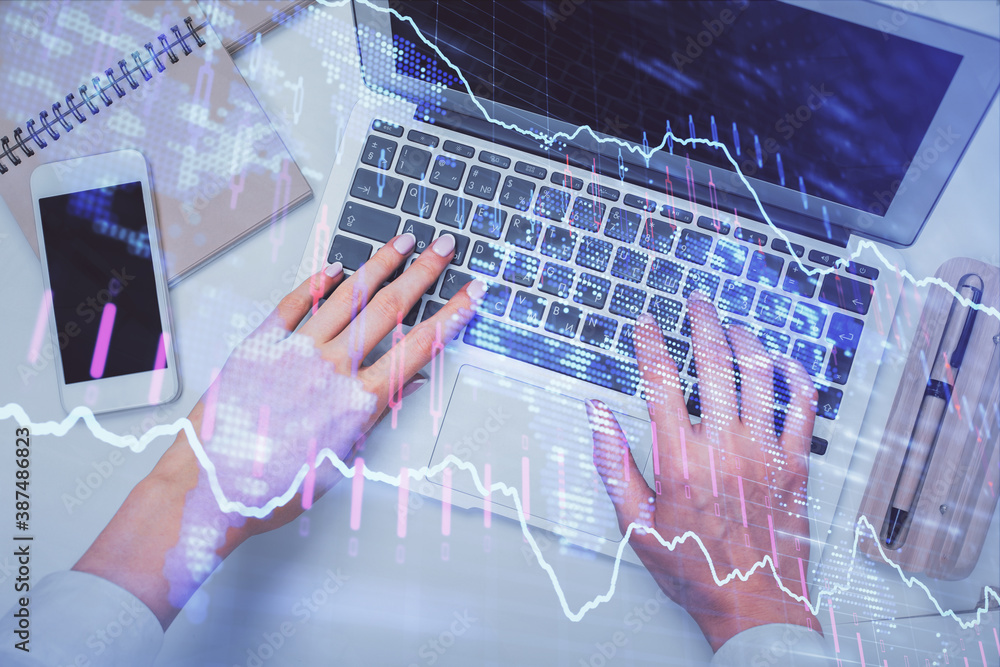 Double exposure of woman hands working on computer and forex graph hologram drawing. Top View. Financial analysis concept. Double exposure of woman hands working on computer and forex graph hologram drawing. Top View. Financial analysis concept.