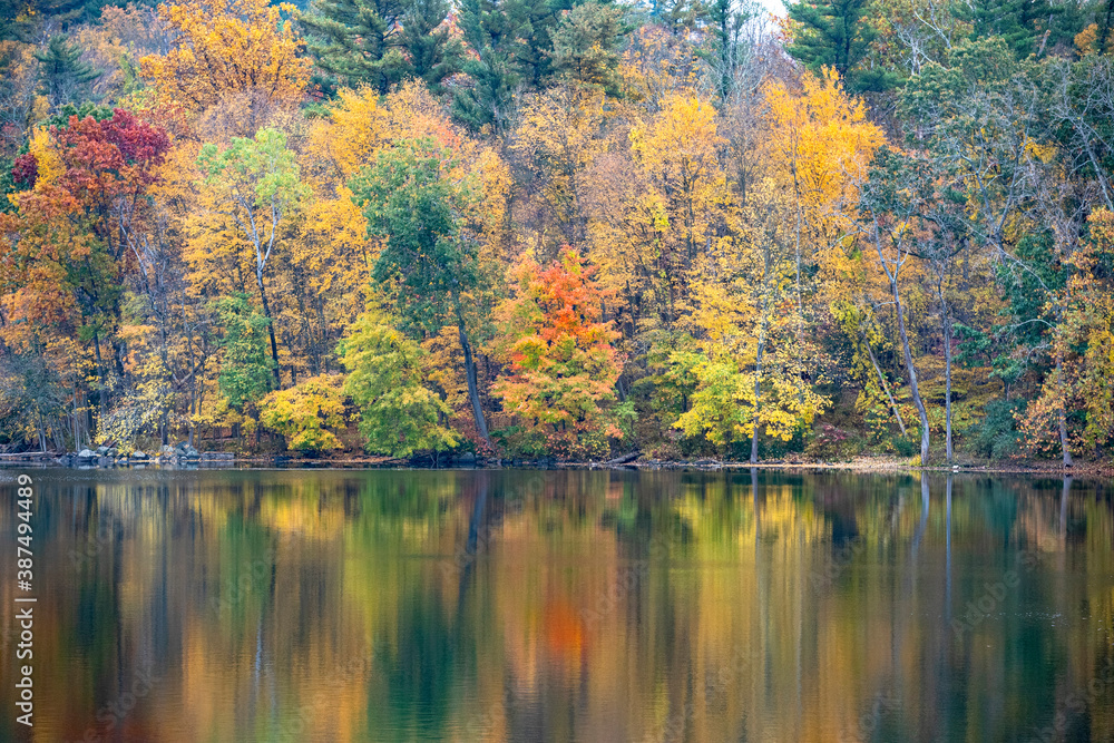 The beauty of autumn colors in the forests reflects off a lake in upstate New York.
