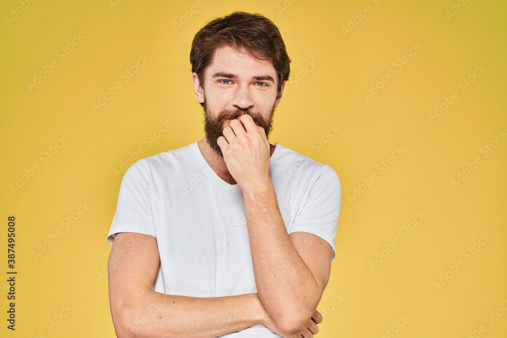Bearded man white t-shirt emotions gestures with hands fun yellow background Bearded man white t-shirt emotions gestures with hands fun yellow background