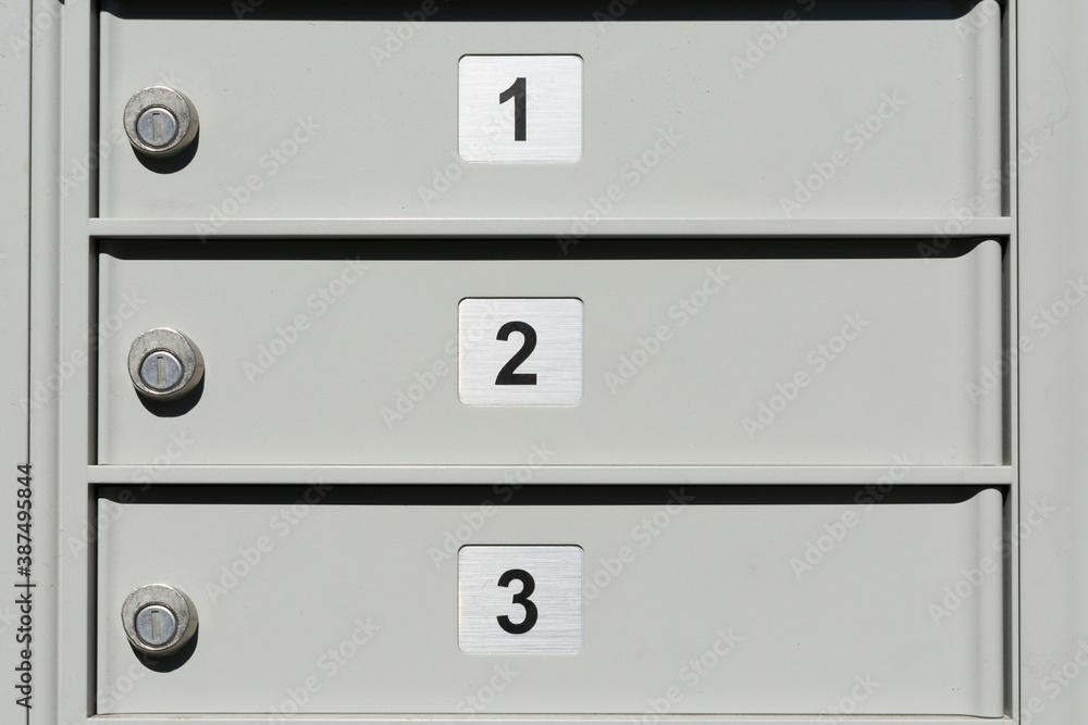 Close up. Locked doors of outdoor apartment mailbox with numbers 1, 2 and 3 Close up. Locked doors of outdoor apartment mailbox with numbers 1, 2 and 3