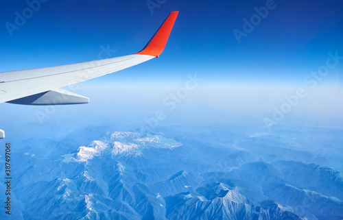 Plane wing on the background of Western Caucasus mountains. Adygeya, Russia.