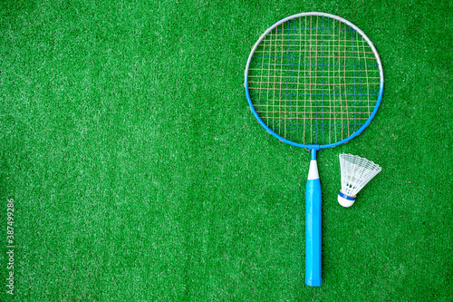 Two badminton mini rackets with white shuttlecock on the green background, active games. copy space