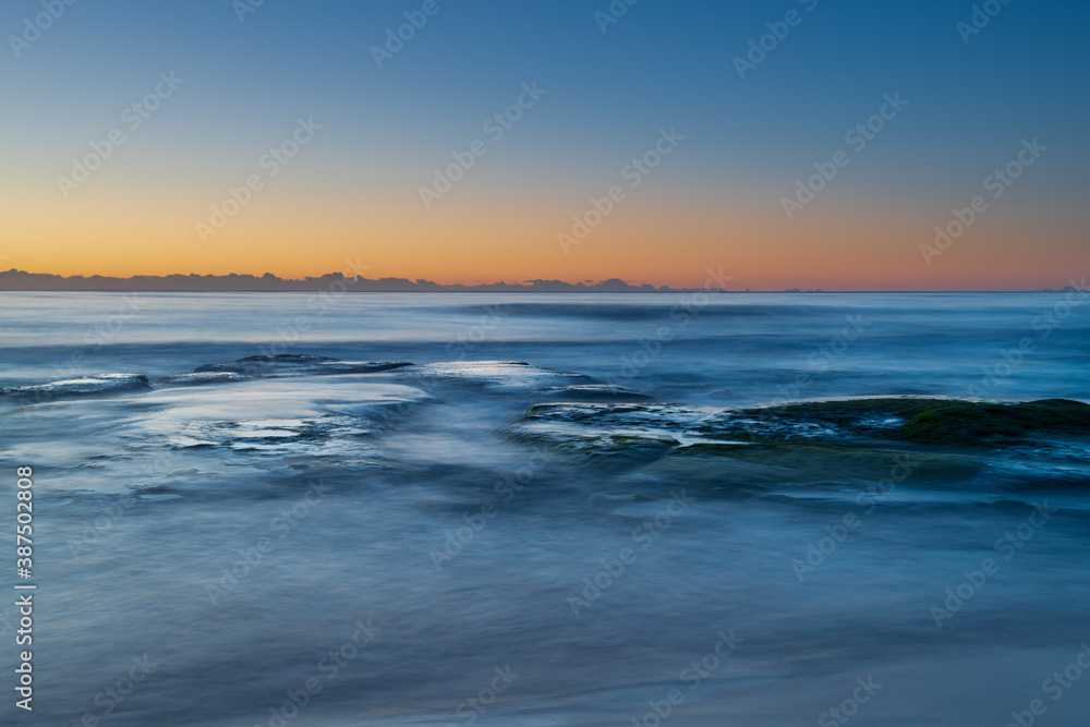 Clear skies and soft seas, dawn at the beach