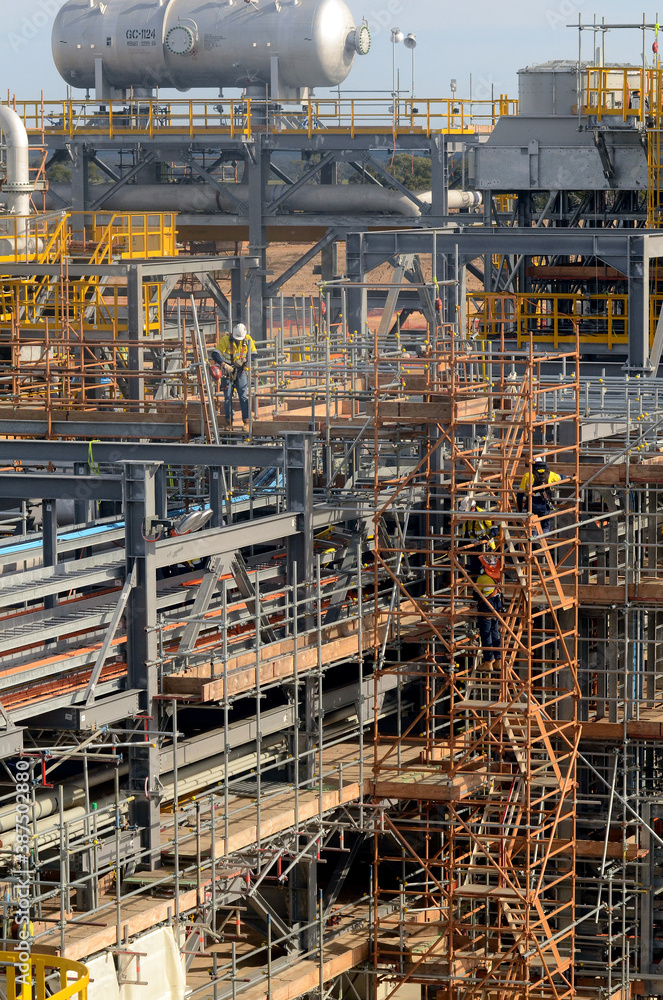 It takes teamwork to build a refinery amongst all the steel scaffolding.