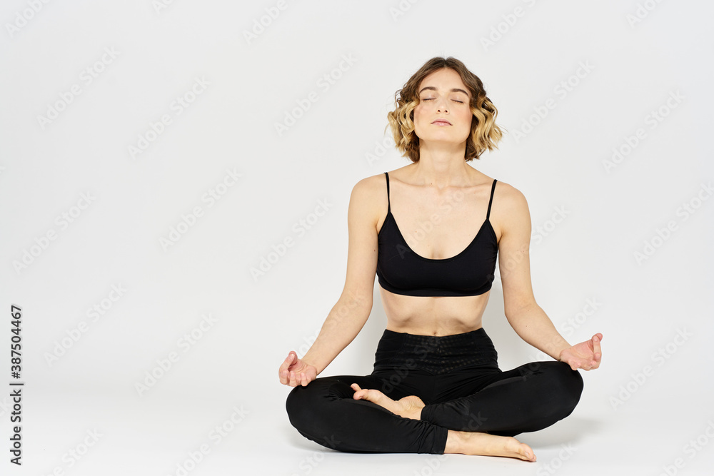 woman in dark clothes sitting on the floor and meditation exercises for legs leggings woman in dark clothes sitting on the floor and meditation exercises for legs leggings