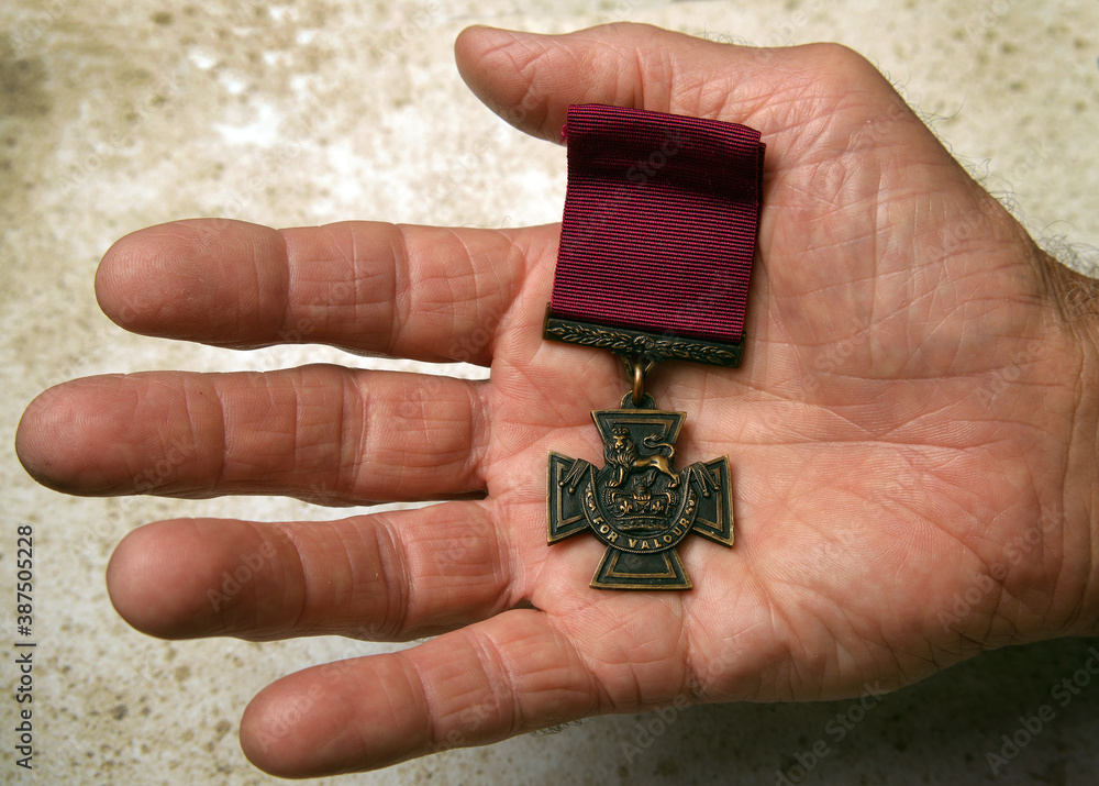 Fototapeta premium The Victoria Cross resting in the hands of an Australian Digger. This is the highest acclamation for valour a soldier can be awarded. 