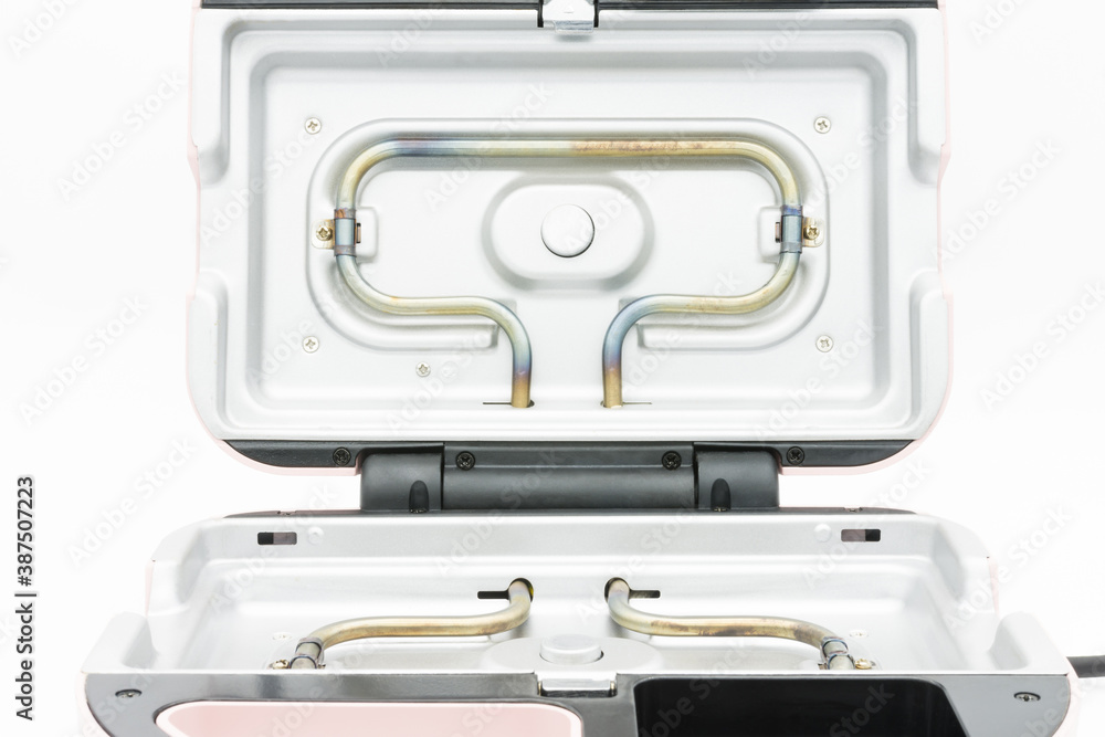 The heating elements on the waffle maker isolated on the white background. The heating elements on the waffle maker isolated on the white background.