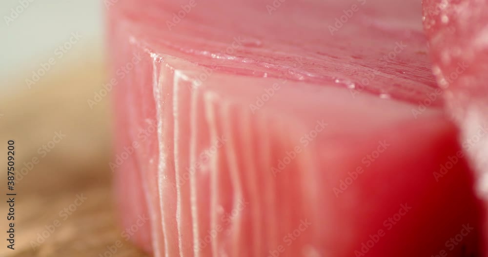 Fresh chunks of raw tuna slowly rotate on the table. Fresh chunks of raw tuna slowly rotate on the table.