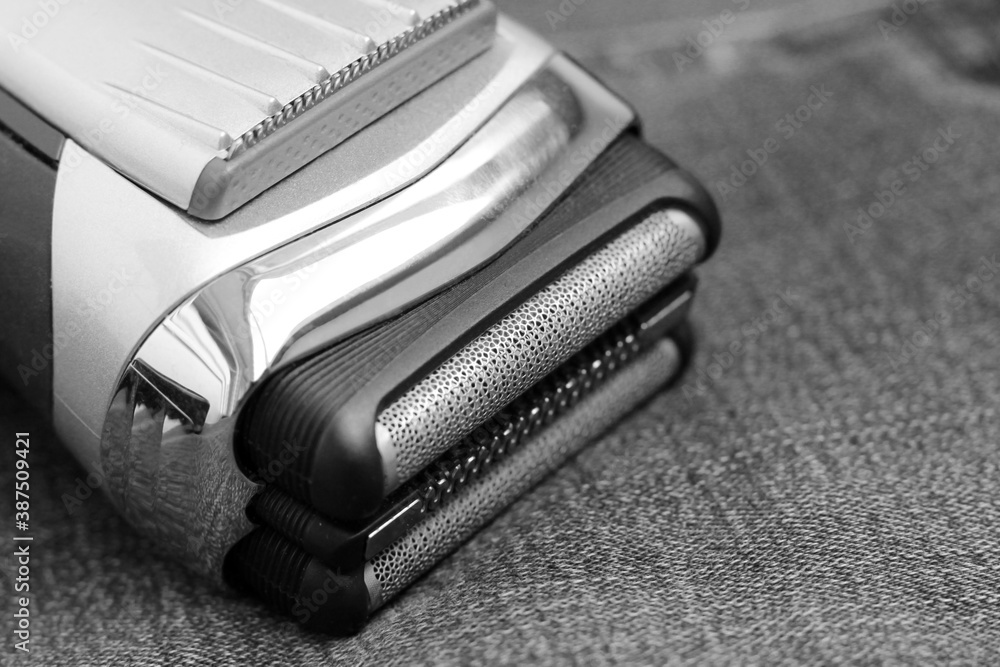 Electric shaver on a jeans, black and white image Electric shaver on a jeans, black and white image