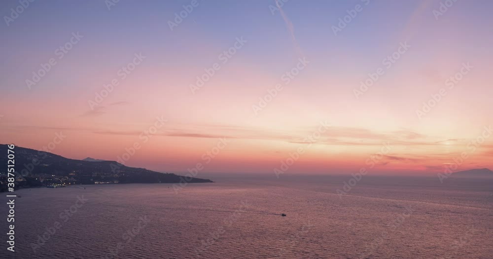 Timelapse video with aerial view of coastline Sorrento city and Gulf of Naples with sun setting behind the sea line. Timelapse video with aerial view of coastline Sorrento city and Gulf of Naples with sun setting behind the sea line.