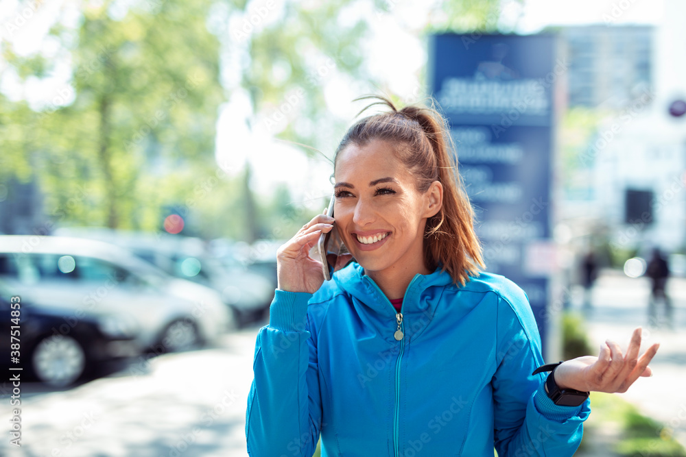 Woman smile while talking on mobile phone on the street Woman smile while talking on mobile phone on the street