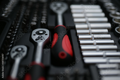 Konstfotografi auto car chrome silver toolbox kit with socket wrench tool and rubber red and bl