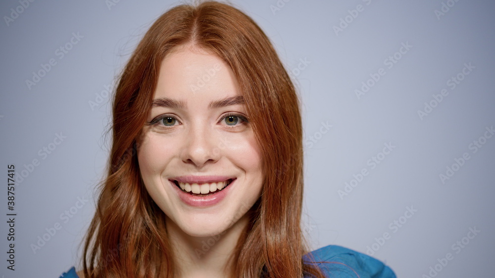 Fototapeta premium Portrait of romantic girl posing indoors. Redhead young woman sending air kisses