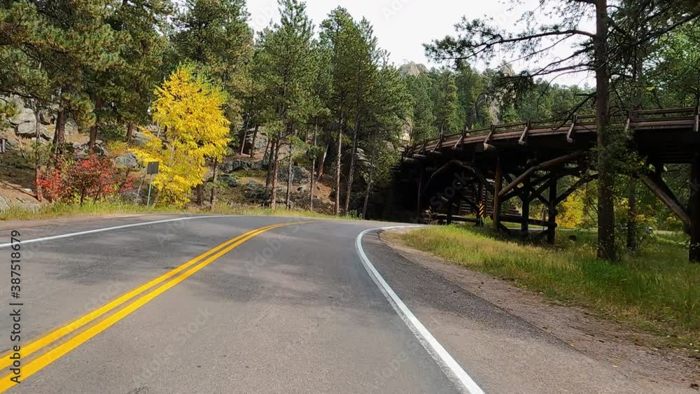 Drive historic bridge autumn Custer South Dakota POV 4K. Black Hills of South Dakota. Mountain