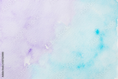 Hand painted purple and blue watercolor shades on paper background.