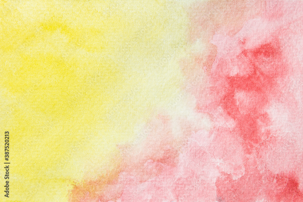 Abstract watercolor wallpaper. Hand painted red and yellow watercolor shades on paper background.