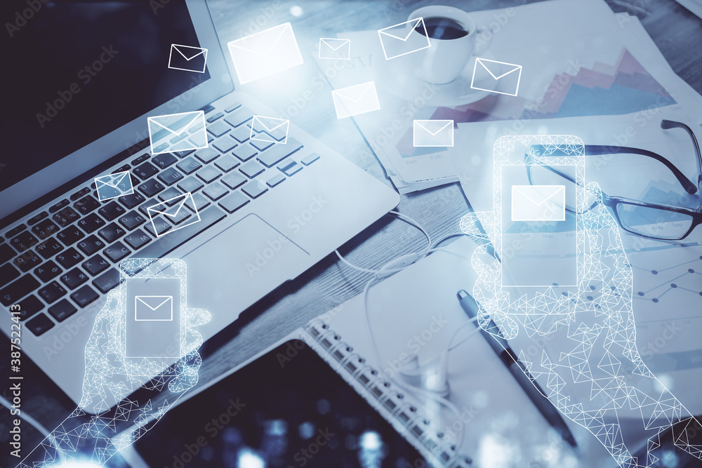 Desktop computer background in office and flying envelops hologram drawing. Double exposure. Electronic mail concept. Desktop computer background in office and flying envelops hologram drawing. Double exposure. Electronic mail concept.