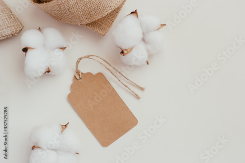Brown cardboard label on a white background with linen and cotton