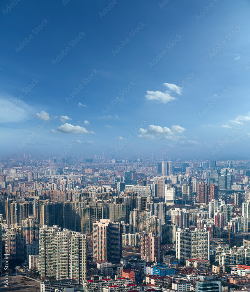 aerial view of Shanghai cityscape and modern skyscraper city in misty sky background behind pollution haze, in Shanghai, China.