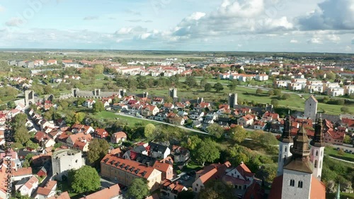 Visby, Gotland, aerial drone footage flying over the town on the Swedish island located in the Baltic Sea. Medieval Town with city wall. Popular tourist destination in Sweden. UNESCO heritage. photo