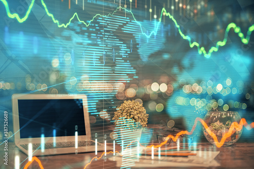 Financial chart drawing and table with computer on background. Multi exposure. Concept of international markets.