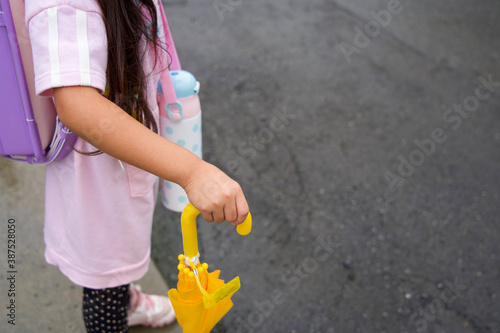 傘を持って通学する女の子の小学生（コピースペース）