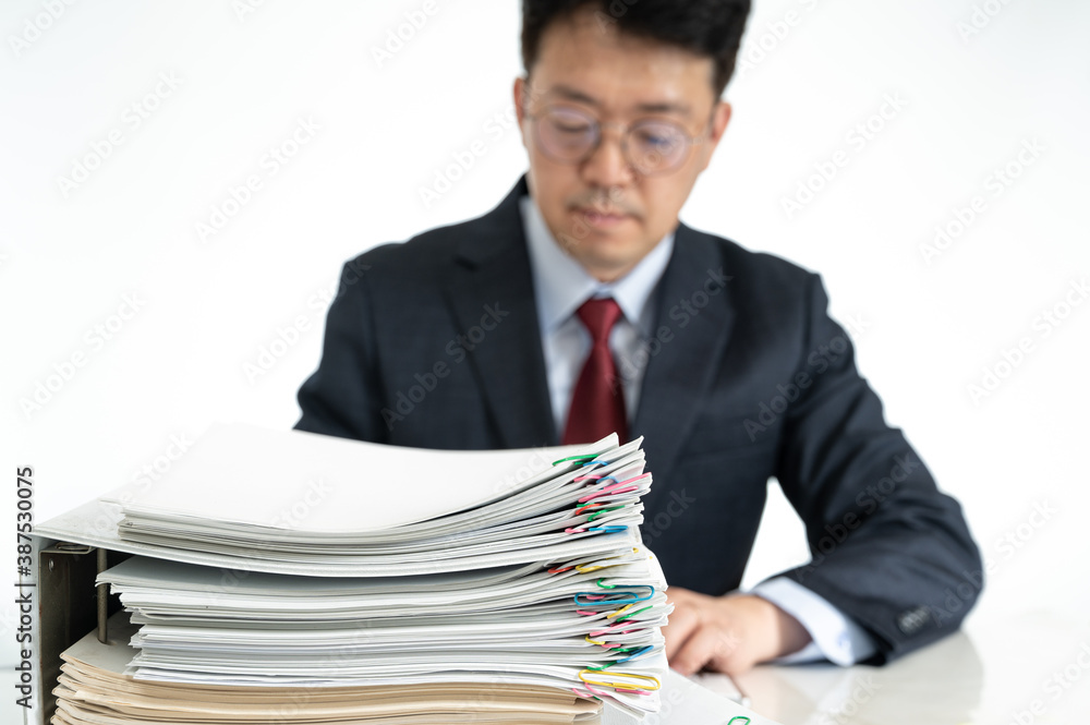 Documents or reports stacked with Asian middle-aged male businessman. Documents or reports stacked with Asian middle-aged male businessman.