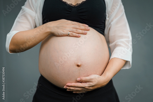 pregnant mother holding her tummy belly